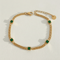 Emerald green stone gold bracelet white background product shot