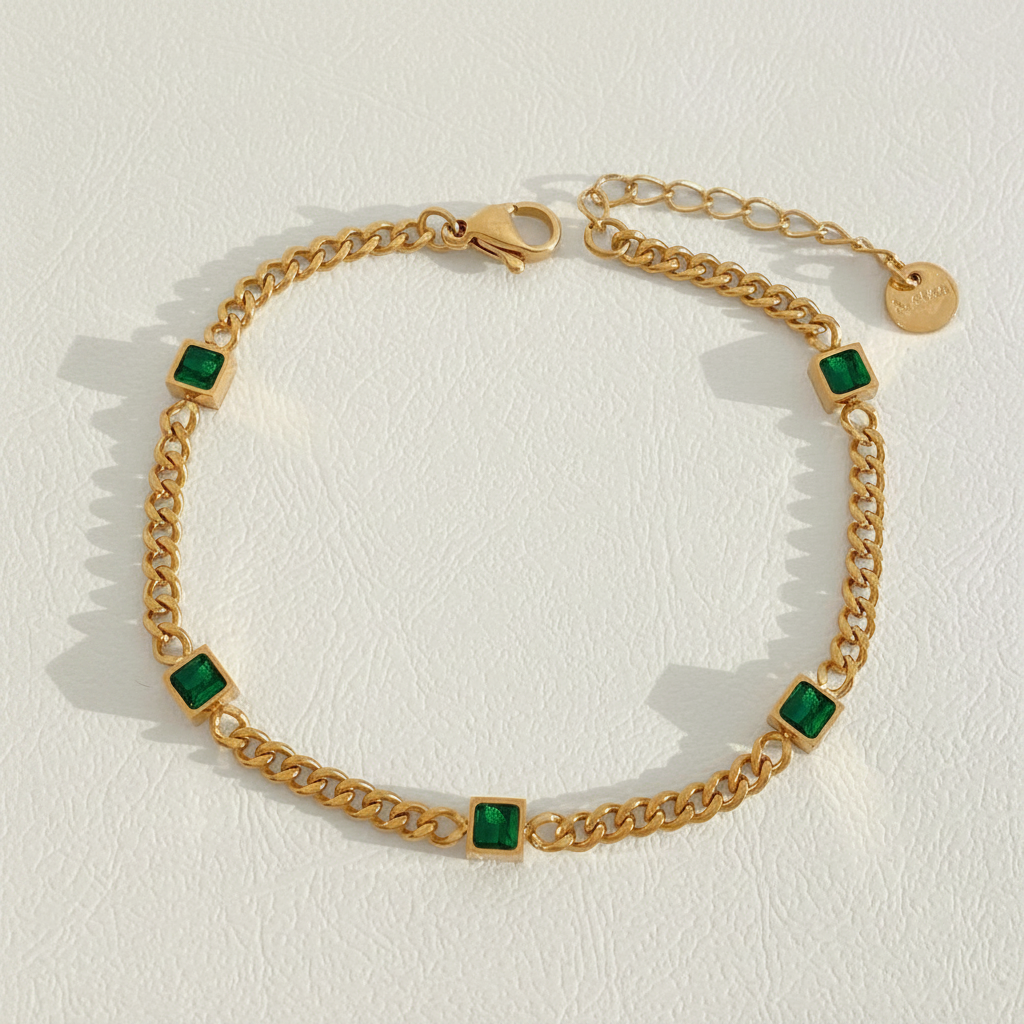 Emerald green stone gold bracelet white background product shot
