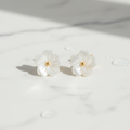 Mother of pearl flower stud earrings on white marble