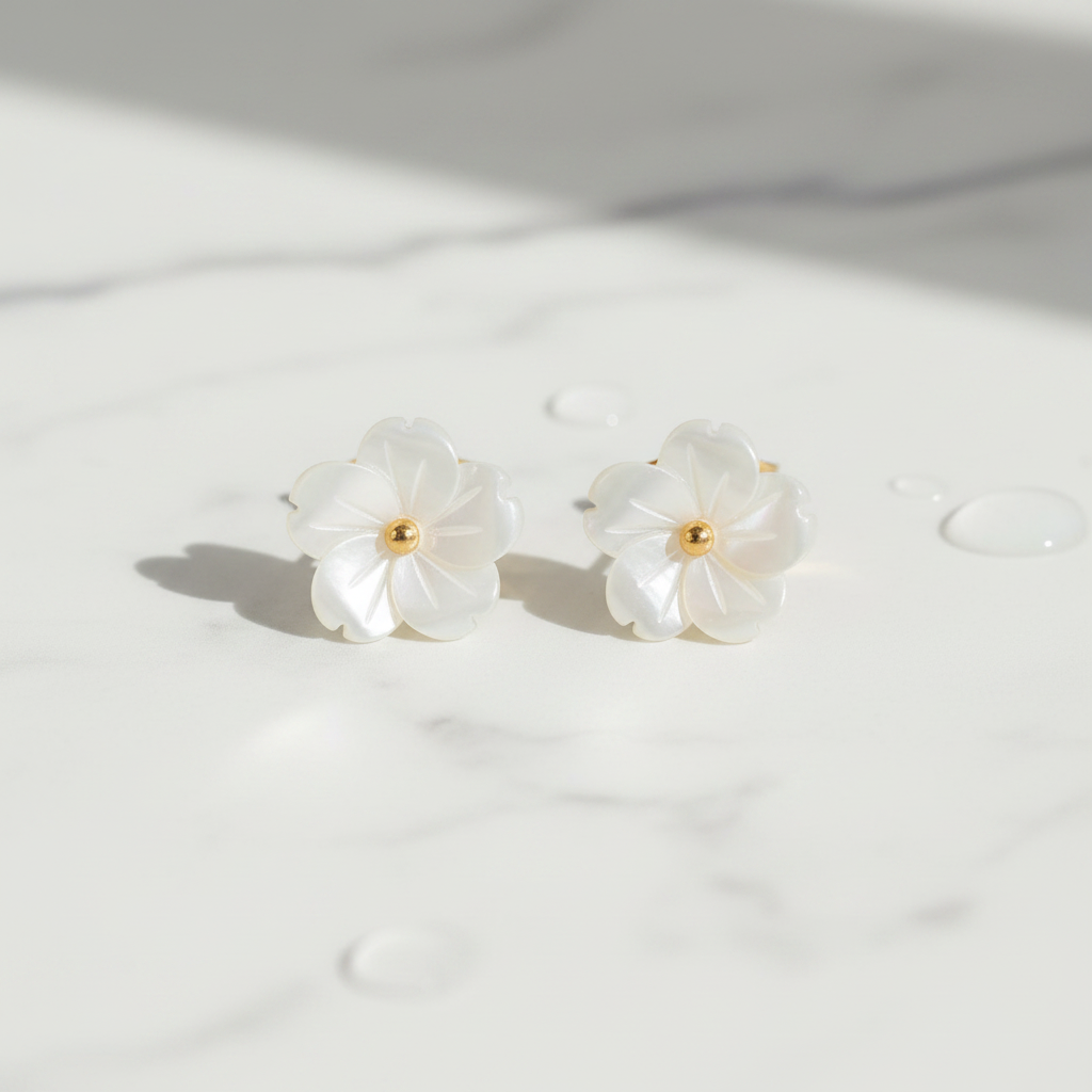 Mother of pearl flower stud earrings on white marble