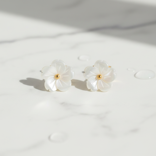 Mother of pearl flower stud earrings on white marble