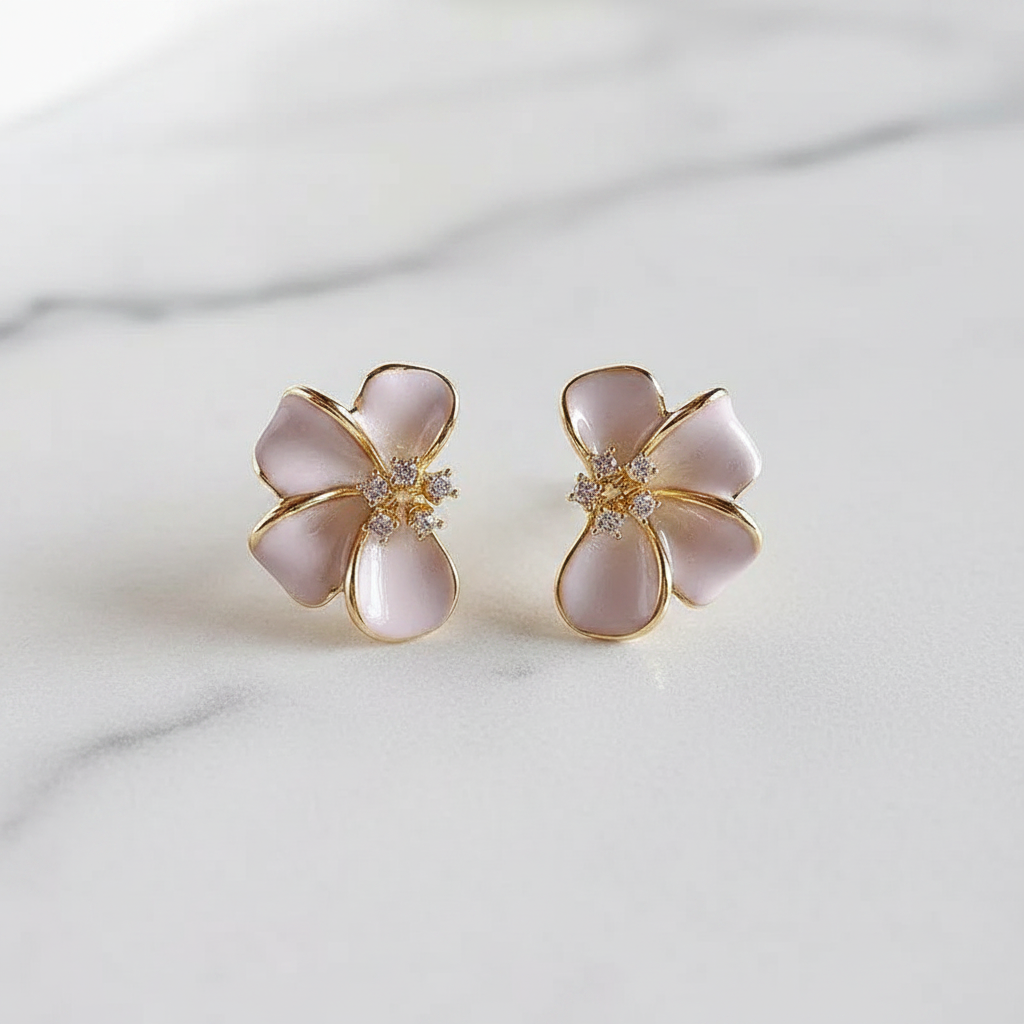 Blush pink flower stud earrings on white marble